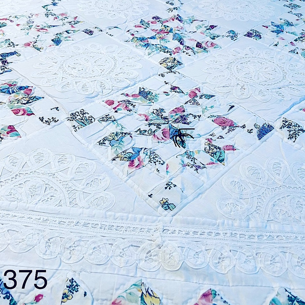 White and Blue Quilted Bedding with Subtle Floral Design
